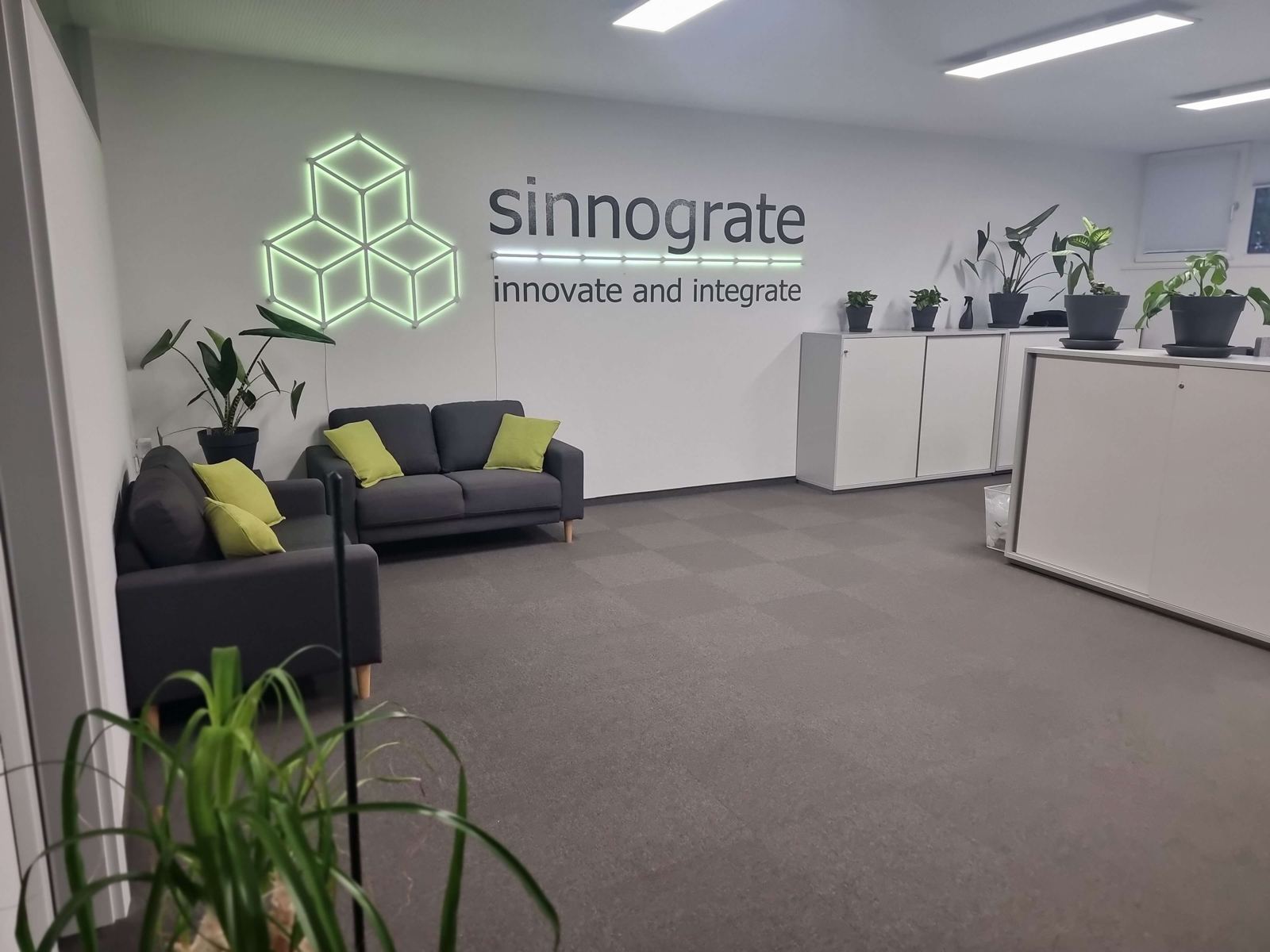 sinnograte reception with seating area and the illuminated company sign